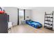 Bright bedroom featuring a racing car bed, sleek ladder shelving, and light wood flooring at 2294 Gold Dust Dr, Minneola, FL 34715