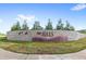 Stone monument sign with landscaping at the entrance to The Hills community at 2294 Gold Dust Dr, Minneola, FL 34715