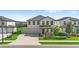 Charming two-story home with a well-manicured lawn, three-car garage and covered front porch at 2294 Gold Dust Dr, Minneola, FL 34715