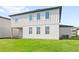 Spacious backyard view of a modern two-story house with pristine lawn at 2294 Gold Dust Dr, Minneola, FL 34715