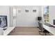Bright home office with wood floors, white walls, built-in cabinets, and a modern desk setup at 2294 Gold Dust Dr, Minneola, FL 34715