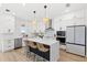 Bright kitchen with stainless steel appliances, quartz counters, white cabinets, and pendant lighting at 2294 Gold Dust Dr, Minneola, FL 34715