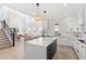 Open-concept kitchen featuring a large island, stainless steel appliances, and modern lighting at 2294 Gold Dust Dr, Minneola, FL 34715