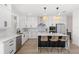 Bright kitchen with stainless steel appliances, quartz counters, white cabinets, and pendant lighting at 2294 Gold Dust Dr, Minneola, FL 34715