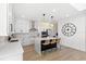 Modern kitchen with white cabinets, a black island, and woven bar stools at the island at 2294 Gold Dust Dr, Minneola, FL 34715