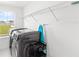 Well-organized laundry room with overhead shelving, modern appliances, and natural light at 2294 Gold Dust Dr, Minneola, FL 34715