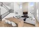 Open floorplan featuring soaring ceilings, a staircase, and a modern fireplace at 2294 Gold Dust Dr, Minneola, FL 34715