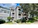 Three-story condo building with balconies, showing architectural details in a pleasant outdoor setting at 2314 Mid Town Ter # 1126, Orlando, FL 32839
