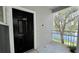 A black front door and a lovely view of the serene lake and lush greenery from the entryway balcony at 2314 Mid Town Ter # 1126, Orlando, FL 32839