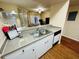 Open kitchen layout offers countertop seating and a view of the living area at 2314 Mid Town Ter # 1126, Orlando, FL 32839