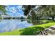 Scenic pond view with ducks and lush landscaping with water reflecting the beautiful cloudy blue sky at 2314 Mid Town Ter # 1126, Orlando, FL 32839