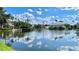 Water view reflecting clouds and palm trees surrounding community on a sunny day at 2314 Mid Town Ter # 1126, Orlando, FL 32839