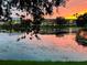 Picturesque sunset view of the community reflecting on the tranquil pond waters at 2314 Mid Town Ter # 1126, Orlando, FL 32839