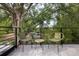 Balcony with outdoor seating, featuring natural light, green foliage, and sleek metal railings at 2412 Chantilly Ave, Winter Park, FL 32789