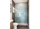 Modern bathroom featuring glass shower with blue subway tile and pebble floor at 2412 Chantilly Ave, Winter Park, FL 32789