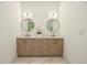 Bathroom featuring dual vanities and a large mirror at 2412 Chantilly Ave, Winter Park, FL 32789