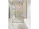 Elegant bathroom with a glass shower, soaking tub, and marble flooring at 2412 Chantilly Ave, Winter Park, FL 32789