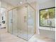Elegant bathroom with a glass shower, soaking tub, and marble flooring at 2412 Chantilly Ave, Winter Park, FL 32789