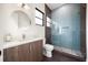 Sleek bathroom boasts a tiled shower, modern vanity, and stylish round mirror for a luxurious experience at 2412 Chantilly Ave, Winter Park, FL 32789