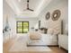 Bright bedroom featuring hardwood floors, tray ceiling and backyard view at 2412 Chantilly Ave, Winter Park, FL 32789