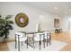 Elegant dining room features a modern light fixture, a mirror, and stylish decor at 2412 Chantilly Ave, Winter Park, FL 32789
