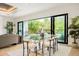 Bright dining area with modern furniture and sliding glass doors overlooking the backyard pool at 2412 Chantilly Ave, Winter Park, FL 32789