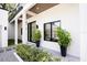 Modern home's exterior with manicured landscaping, sleek columns, and contemporary black-framed windows at 2412 Chantilly Ave, Winter Park, FL 32789