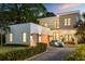 Stunning modern home featuring a two-car garage, elegant balcony, and a manicured lawn at 2412 Chantilly Ave, Winter Park, FL 32789