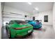 Modern garage featuring epoxy floors, white walls, and two luxury sports cars at 2412 Chantilly Ave, Winter Park, FL 32789