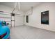 Well lit garage featuring epoxy floors, with a window to view the green sports car parked outside at 2412 Chantilly Ave, Winter Park, FL 32789