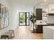 Hallway view shows front door, large art, and flows into the kitchen area at 2412 Chantilly Ave, Winter Park, FL 32789