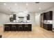 Modern kitchen with a large island, stainless steel appliances, and wood floors at 2412 Chantilly Ave, Winter Park, FL 32789