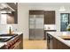 Modern kitchen features stainless steel appliances, custom cabinetry, and bright white countertops at 2412 Chantilly Ave, Winter Park, FL 32789