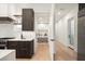 Kitchen with stylish cabinets, open shelving and a pantry with shelves for storing food at 2412 Chantilly Ave, Winter Park, FL 32789
