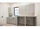 Clean laundry room featuring lots of cabinets, counter space, and a sink at 2412 Chantilly Ave, Winter Park, FL 32789