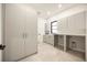 Spacious laundry room with ample cabinetry, countertop space and modern fixtures at 2412 Chantilly Ave, Winter Park, FL 32789