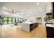 Open-concept living area with hardwood floors, a spacious island, and abundant natural light at 2412 Chantilly Ave, Winter Park, FL 32789