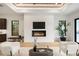 Cozy living room with a modern fireplace, large windows, and hardwood flooring at 2412 Chantilly Ave, Winter Park, FL 32789