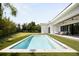 Backyard pool with a modern house, outdoor seating, and well-manicured landscaping at 2412 Chantilly Ave, Winter Park, FL 32789