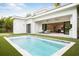 Backyard swimming pool next to outdoor seating and house with sliding glass doors at 2412 Chantilly Ave, Winter Park, FL 32789