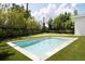 Backyard swimming pool surrounded by lush landscaping and pristine lawn at 2412 Chantilly Ave, Winter Park, FL 32789