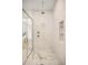 Detailed view of the glass shower with gold hardware and marble flooring at 2412 Chantilly Ave, Winter Park, FL 32789