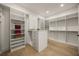 Spacious walk-in closet features custom shelving and a center island with drawers, providing ample storage at 2412 Chantilly Ave, Winter Park, FL 32789