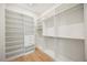 Bright walk-in closet features a built in shelving system and hanging rods for optimal organization at 2412 Chantilly Ave, Winter Park, FL 32789