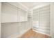 Bright walk-in closet features a built in shelving system and hanging rods for optimal organization at 2412 Chantilly Ave, Winter Park, FL 32789