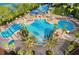 Stunning aerial view of the community pool with waterslides and lush landscaping at 2778 Almaton Loop # 302, Kissimmee, FL 34747