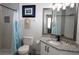 Charming bathroom with a shower, stylish curtain, and modern vanity featuring a granite countertop and sleek black hardware at 2778 Almaton Loop # 302, Kissimmee, FL 34747