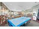 Community game room boasts air hockey, billiard tables, classic arcade games, bar stool seating and large windows at 2778 Almaton Loop # 302, Kissimmee, FL 34747