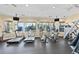 A community gym with treadmills, ellipticals, weight machines, and TV screens for exercise and enjoyment at 2778 Almaton Loop # 302, Kissimmee, FL 34747