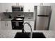 Modern kitchen featuring stainless steel appliances, granite countertops, a stylish backsplash and a black sink at 2778 Almaton Loop # 302, Kissimmee, FL 34747